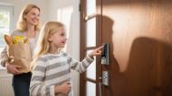 Child unlocking TCL smart lock on front door