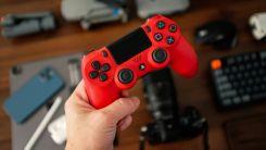 Person Holding a Red PS4 Controller